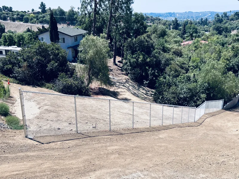 Chain-link fencing along a hillside