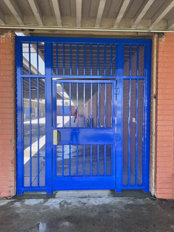 Steel security gate with mesh infill